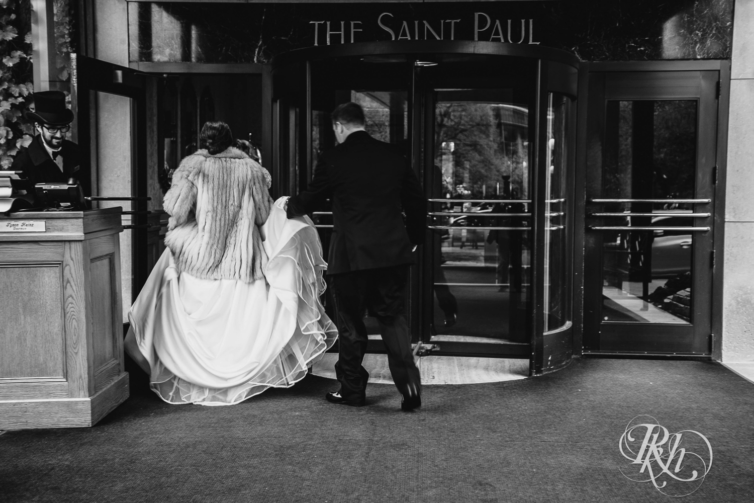 Bride and groom smile at The Saint Paul Hotel in Saint Paul, Minnesota.