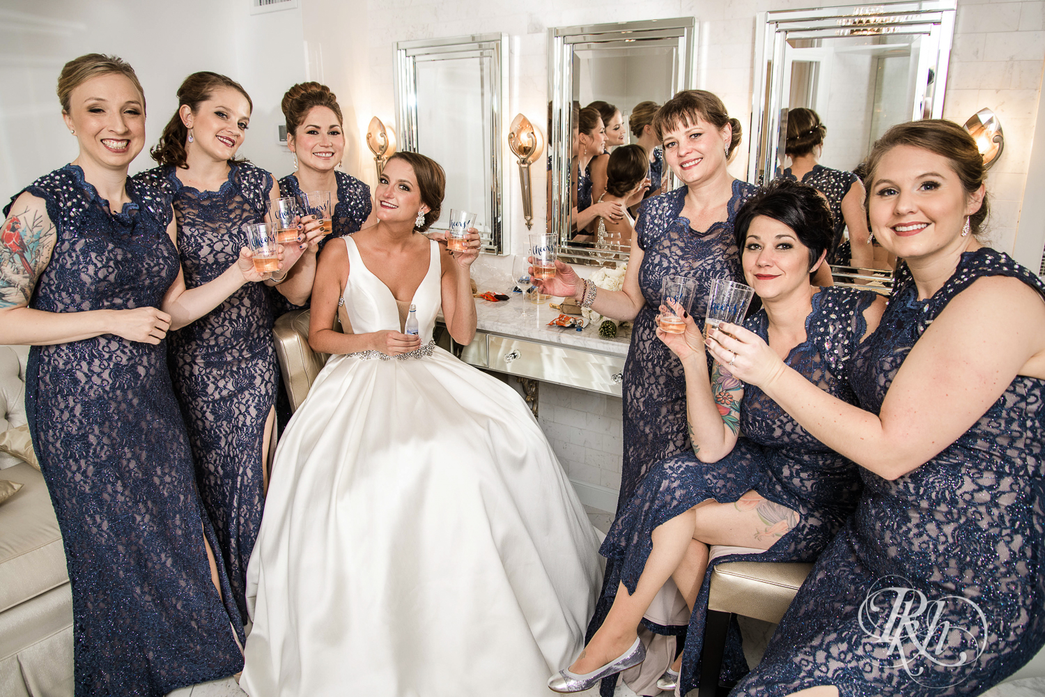 Wedding party smiles in bridal suite with bride at The Saint Paul Hotel in Saint Paul, Minnesota.