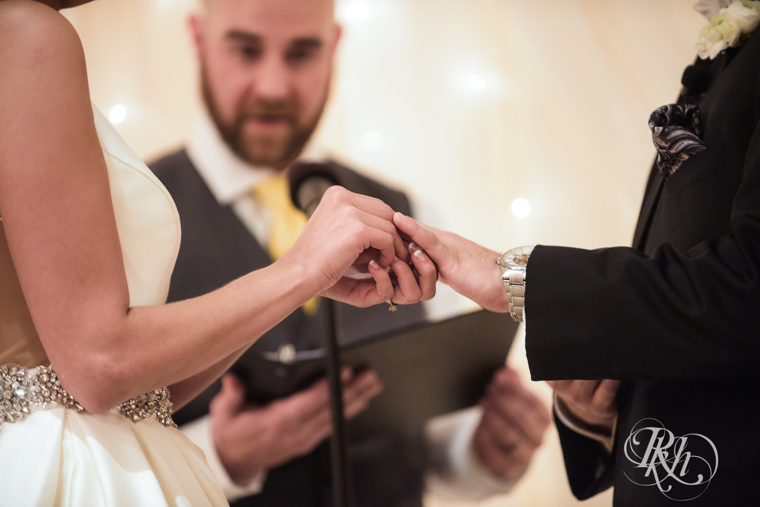 Bride and groom exchange rings during wedding ceremony at The Saint Paul Hotel in Saint Paul, Minnesota.