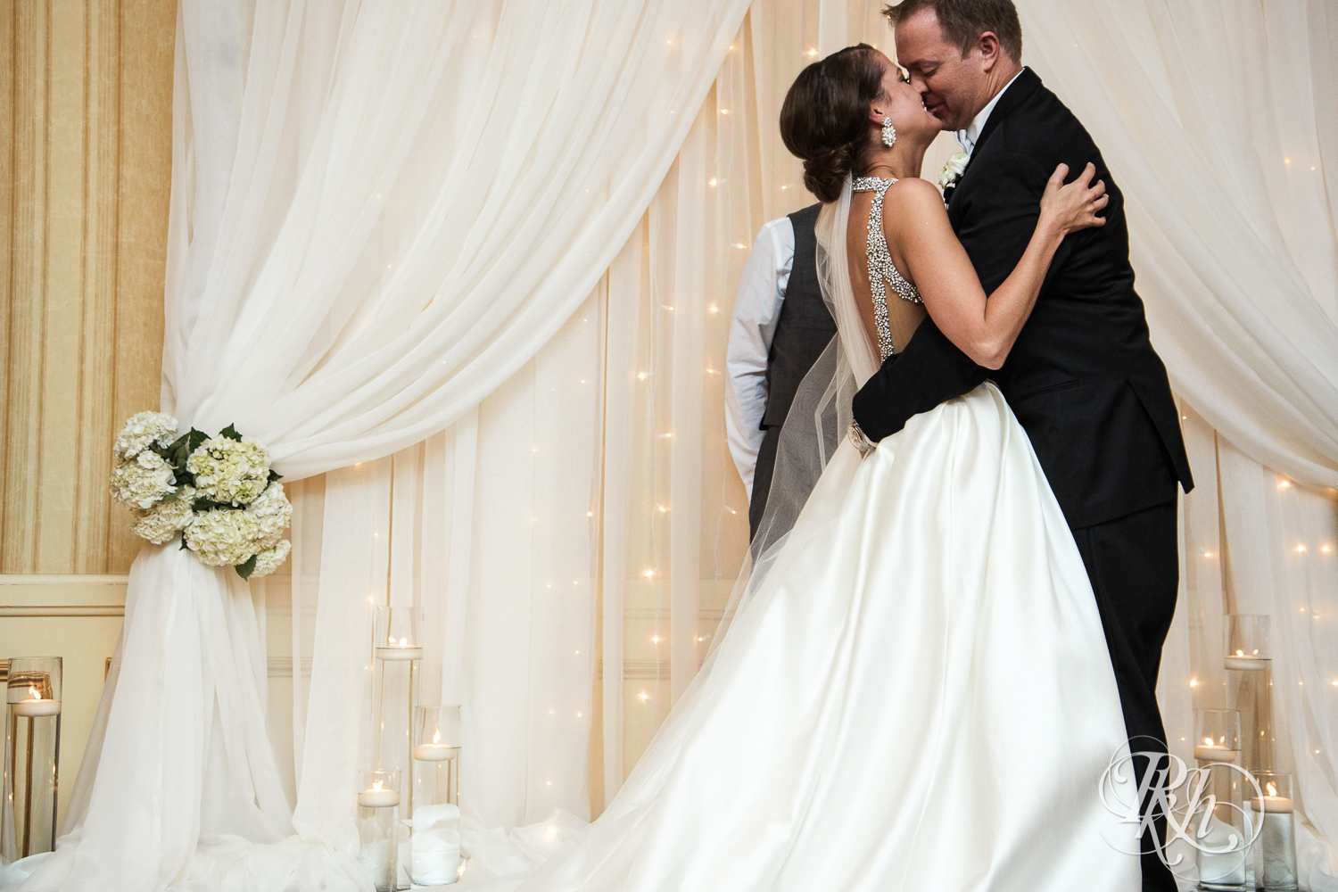 Bride and groom kiss during wedding ceremony at The Saint Paul Hotel in Saint Paul, Minnesota.
