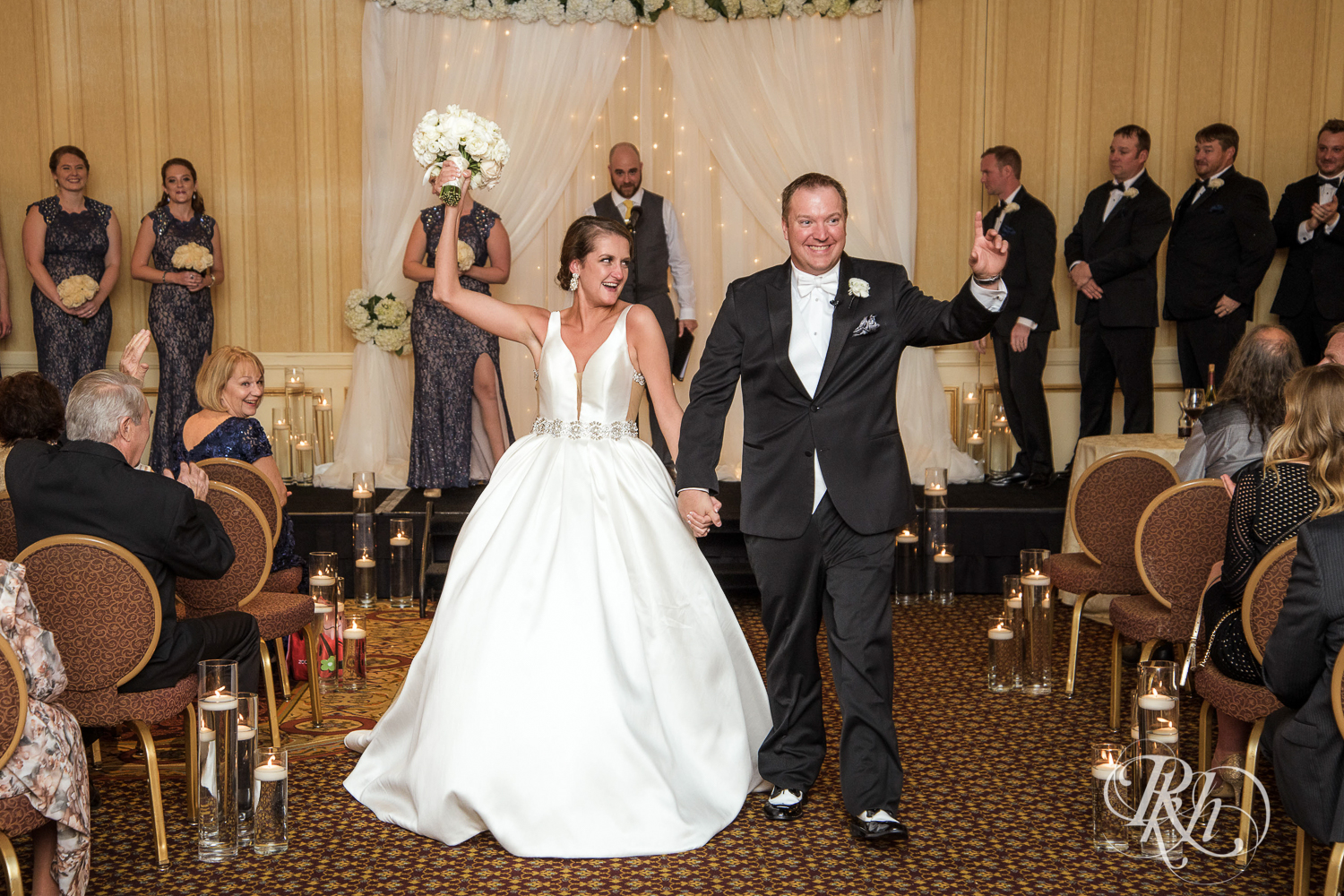 Bride and groom smile after wedding ceremony at The Saint Paul Hotel in Saint Paul, Minnesota.