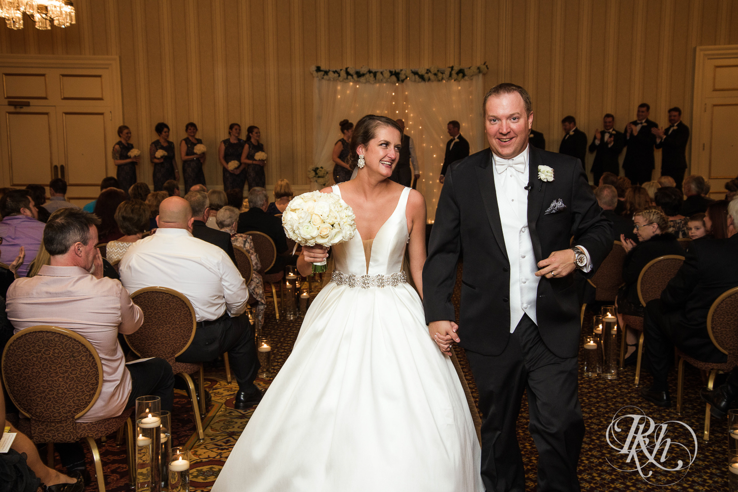 Bride and groom smile after wedding ceremony at The Saint Paul Hotel in Saint Paul, Minnesota.