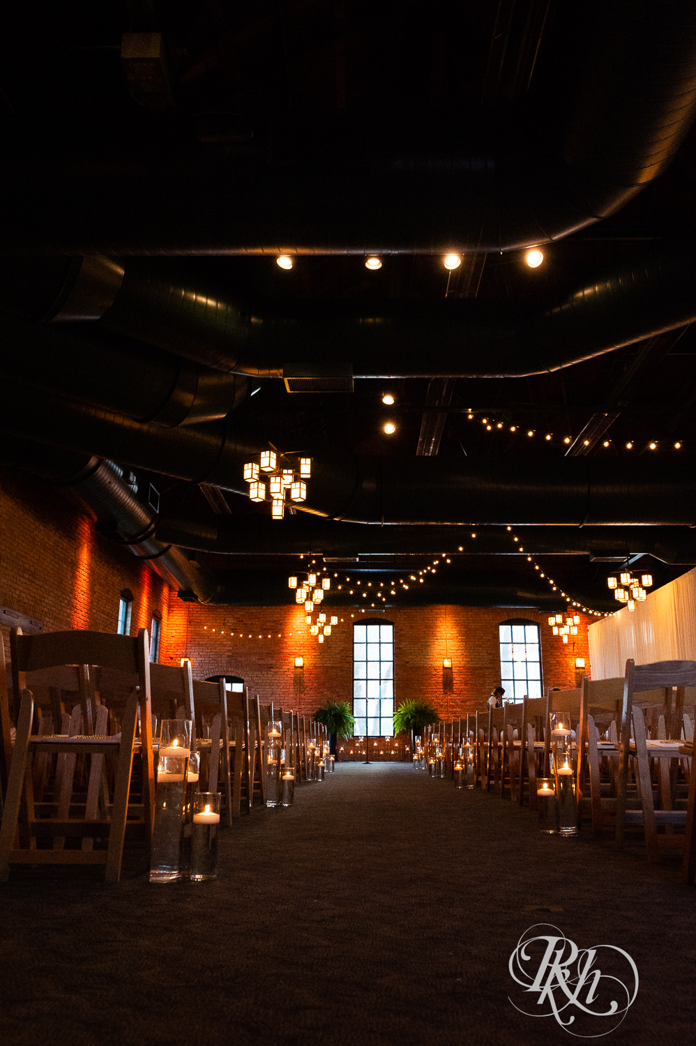 Indoor ceremony setup with candles for a Nicollet Island Pavilion Wedding.