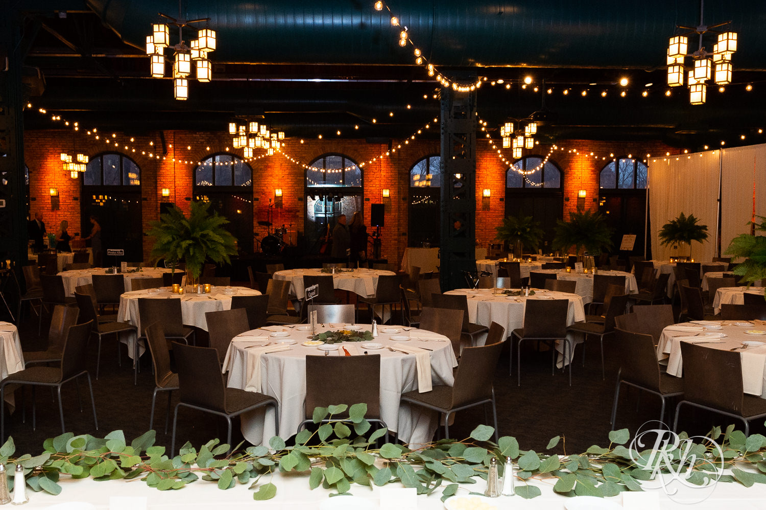 Indoor wedding reception setup at Nicollet Island Pavilion in Minneapolis, Minnesota. 