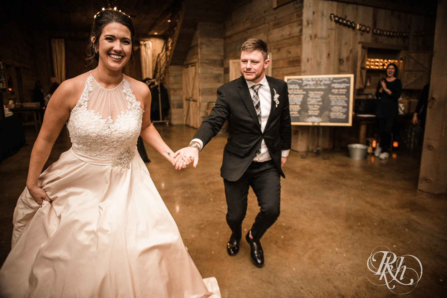 Bride and groom enter new year's eve wedding reception at Creekside Farm in Rush City, Minnesota.