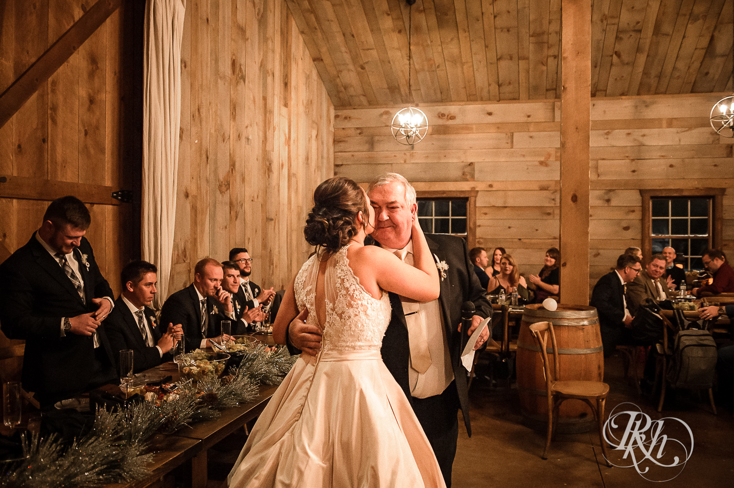 Bride and groom smile during new year's eve wedding reception at Creekside Farm in Rush City, Minnesota.