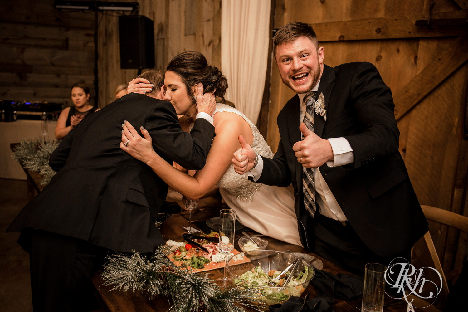 Groom gives thumbs up during wedding reception speeches at Creekside Farm in Rush City, Minnesota.