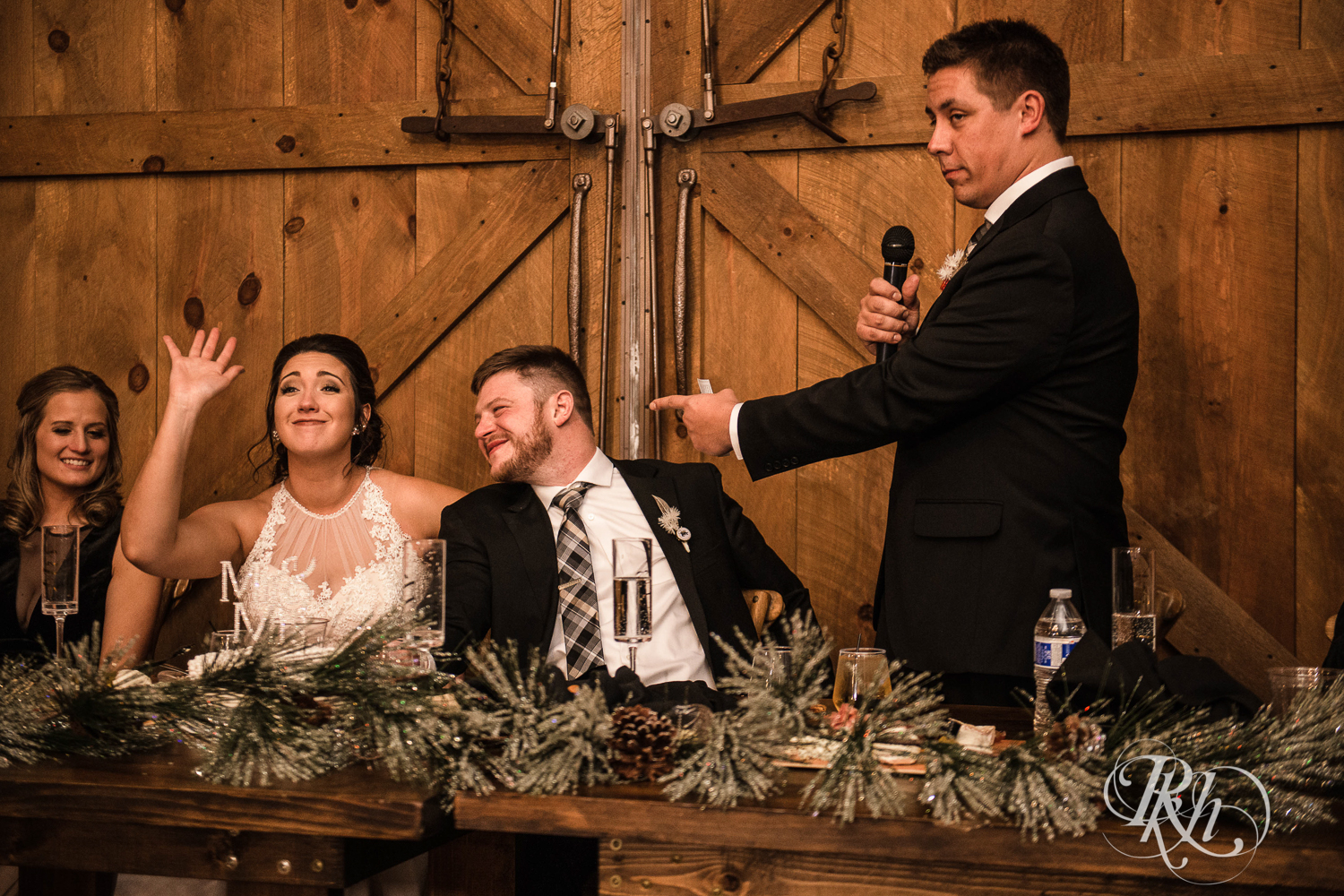 Bride and groom laugh during wedding speeches at Creekside Farm in Rush City, Minnesota.