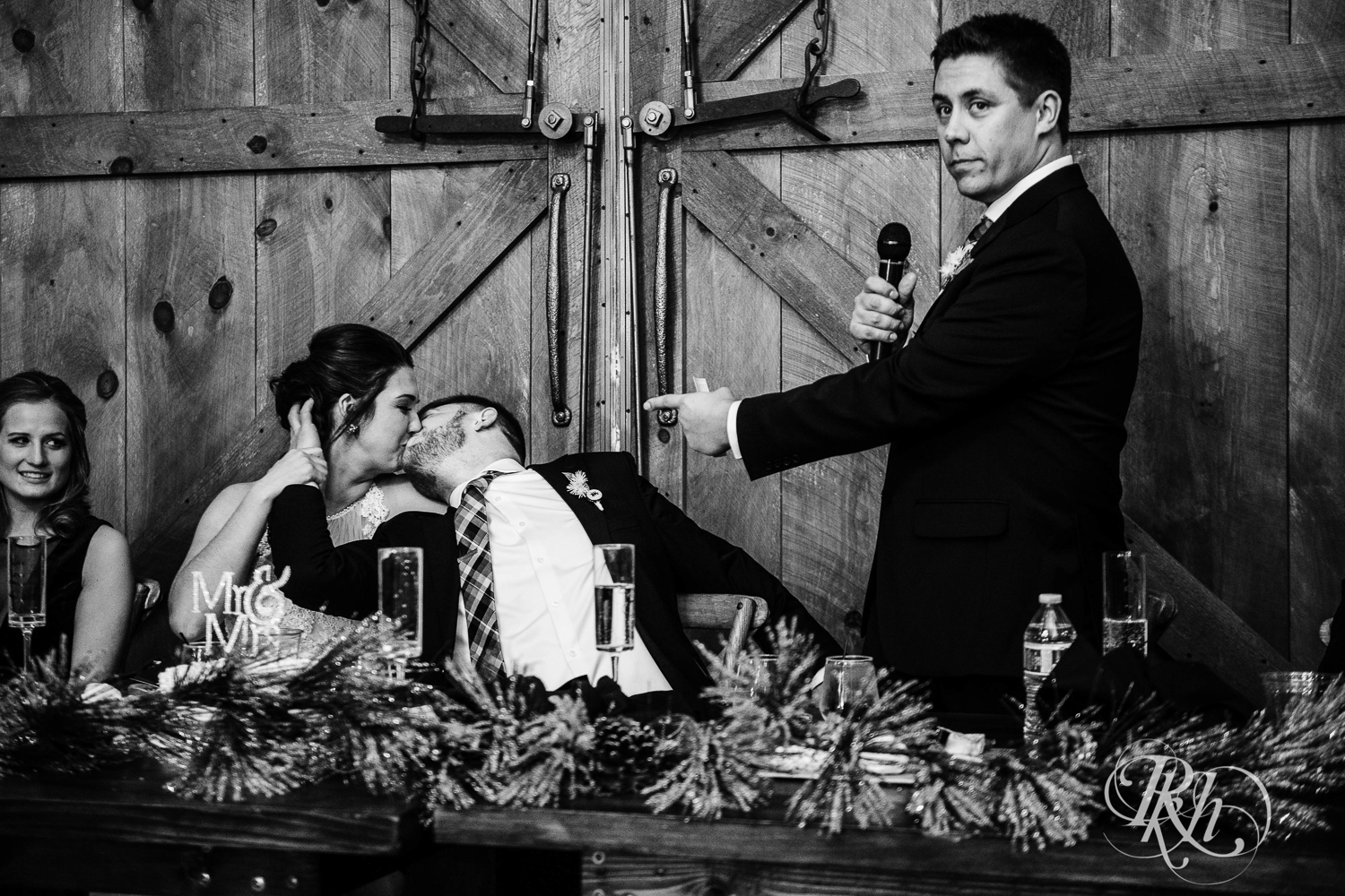 Bride and groom laugh during wedding speeches at Creekside Farm in Rush City, Minnesota.