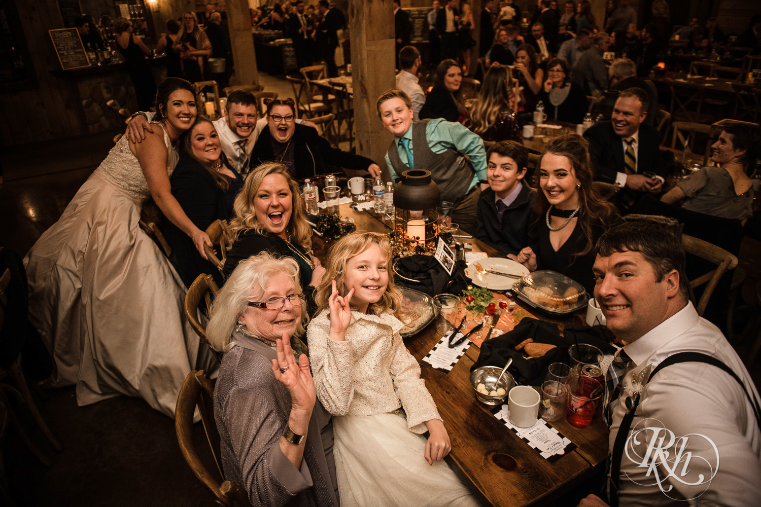 Bride and groom smile with guests during reception at Creekside Farm in Rush City, Minnesota.