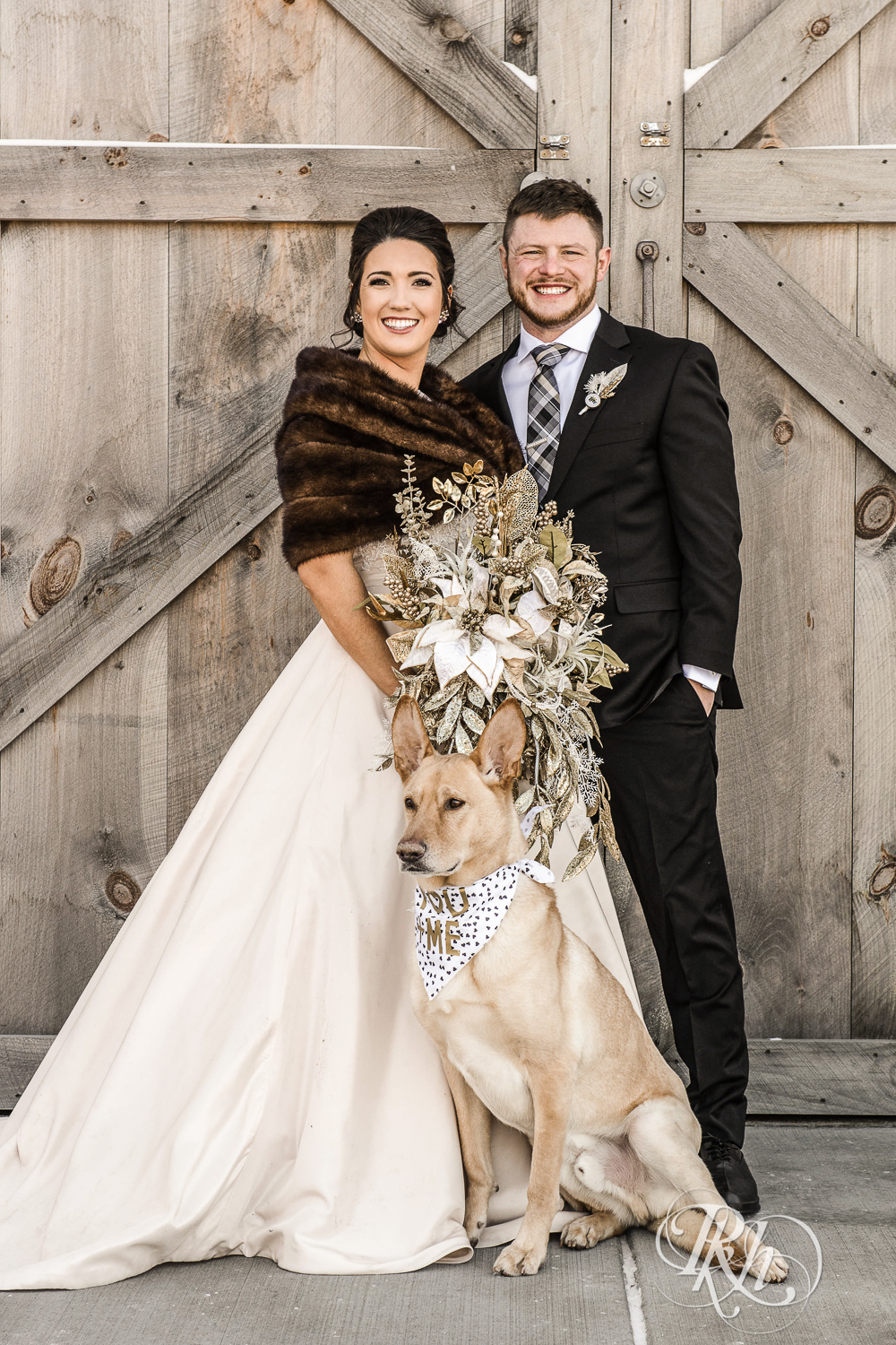 Bride and groom smile with their German Shepard during winter wedding at Creekside Farm in Rush City, Minnesota.