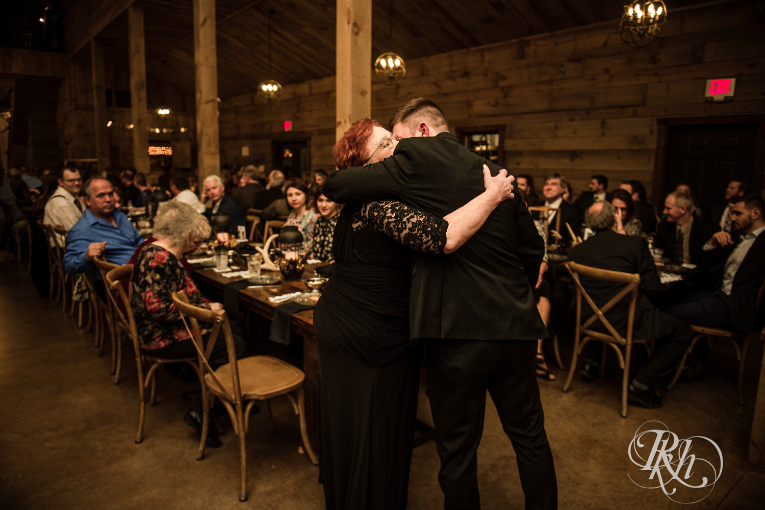 Groom hugs mom during new year's eve wedding ceremony at Creekside Farm in Rush City, Minnesota.