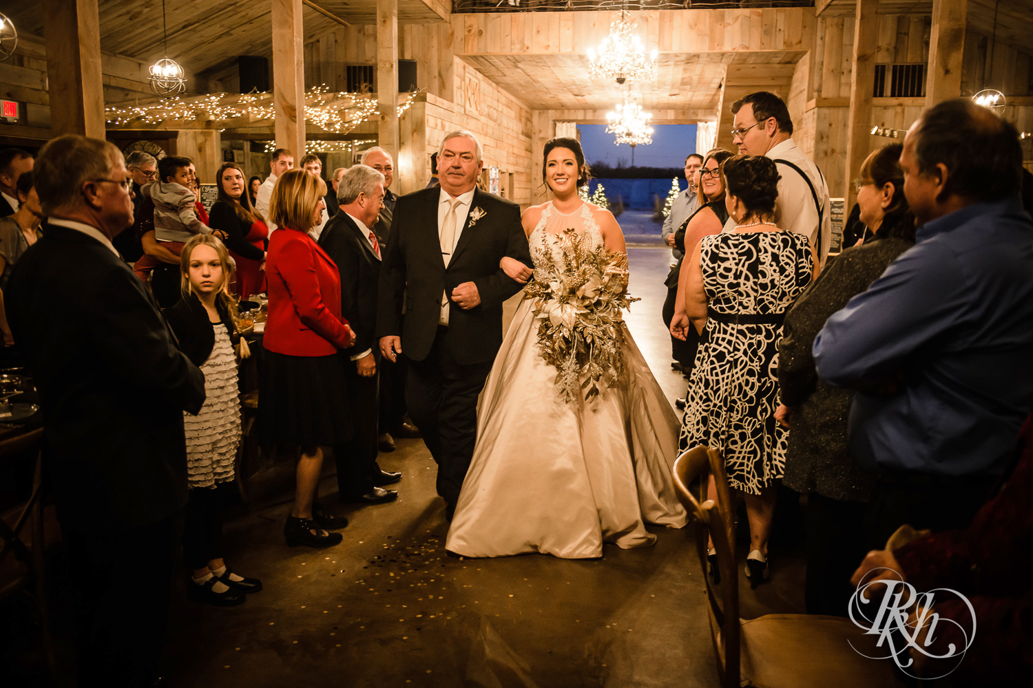 Bride walks down the aisle during new year's eve wedding ceremony at Creekside Farm in Rush City, Minnesota.