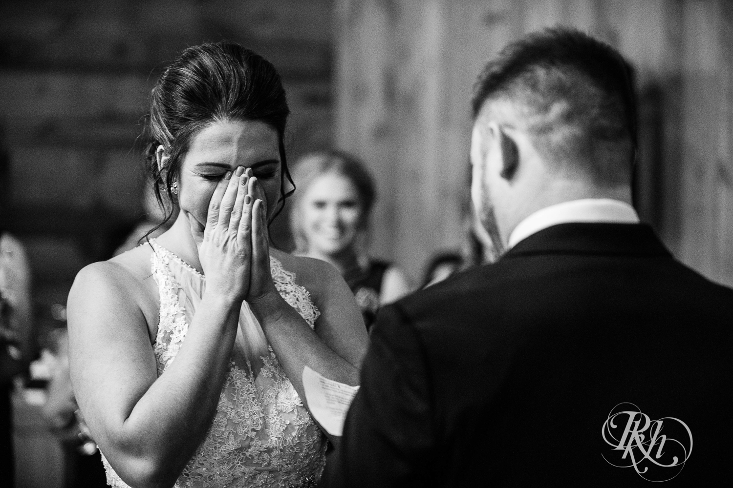 Bride and groom smile during new year's eve wedding ceremony at Creekside Farm in Rush City, Minnesota.