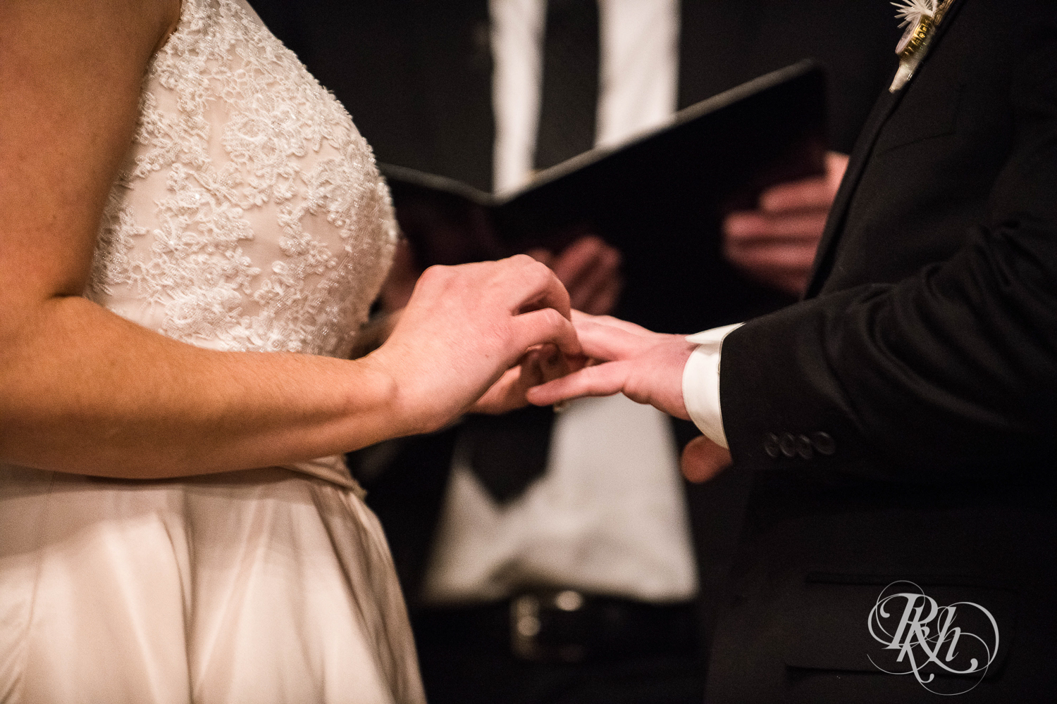 Bride and groom exchange rings during new year's eve wedding ceremony at Creekside Farm in Rush City, Minnesota.