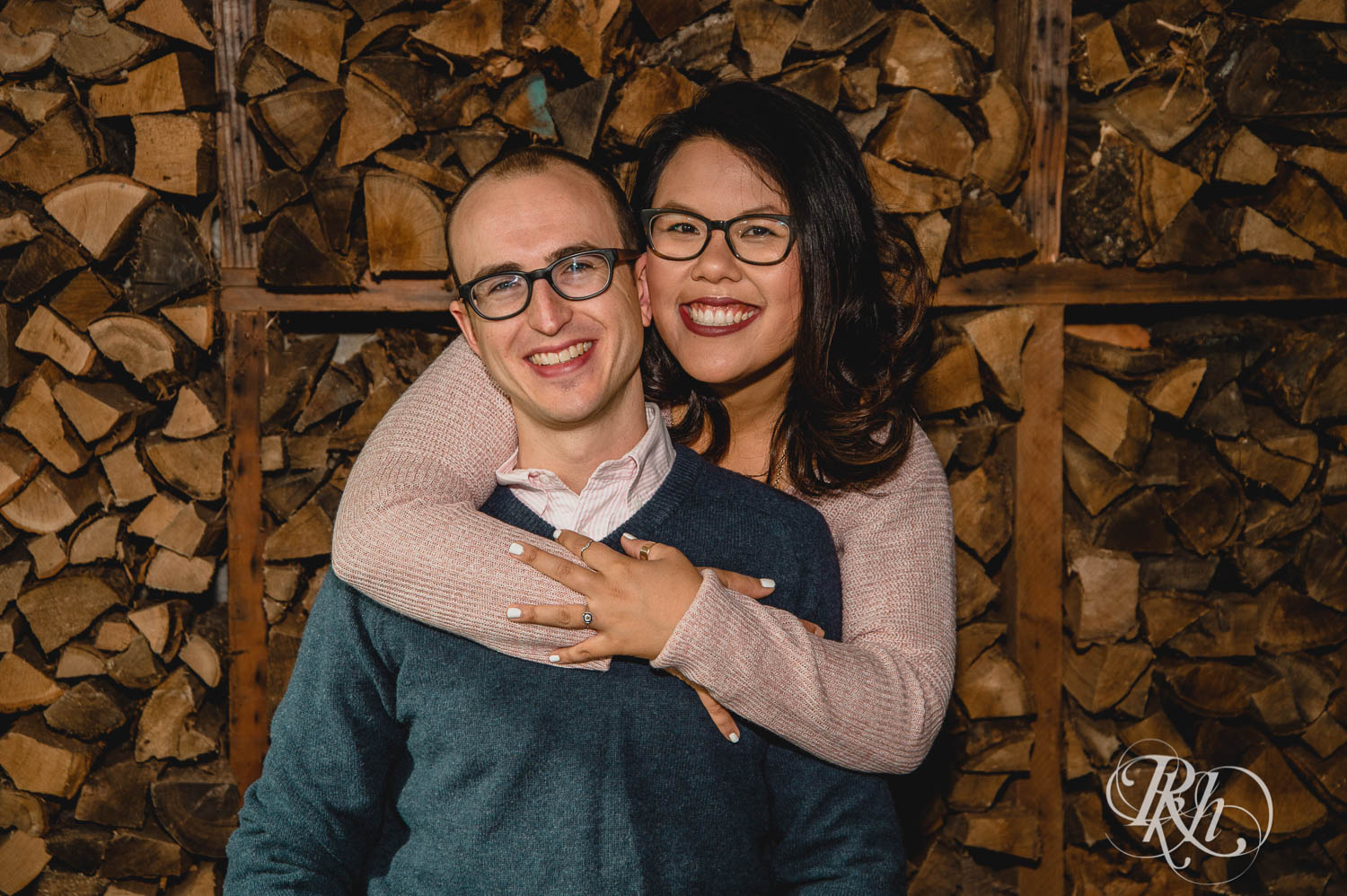 Man and Asian woman in glasses smile for Young Joni engagement photos in Minneapolis, Minnesota.