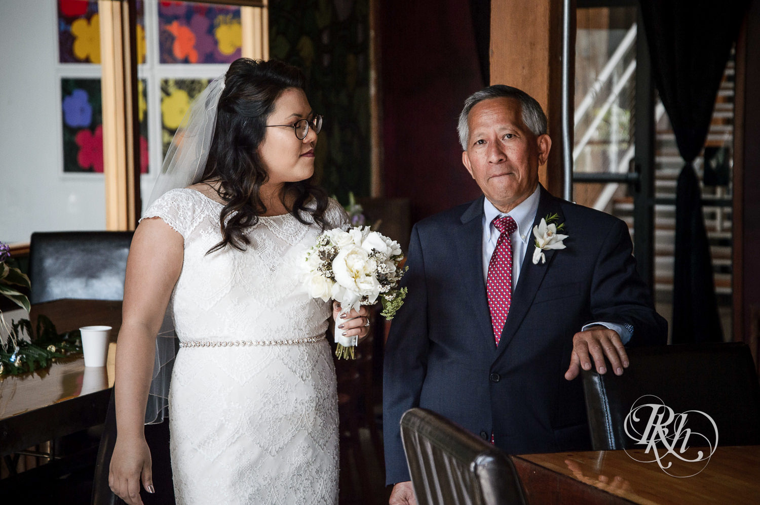 Asian bride stands with dad before wedding ceremony at 612 Brew in Minneapolis, Minnesota.
