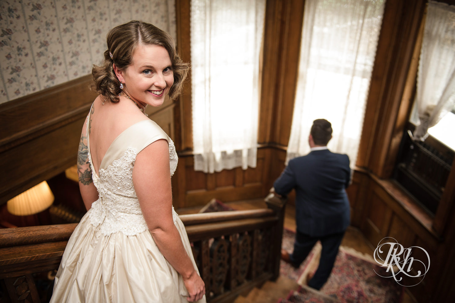 Bride and groom doing first look on stairs at Summit Manor Reception House in Saint Paul, Minnesota.