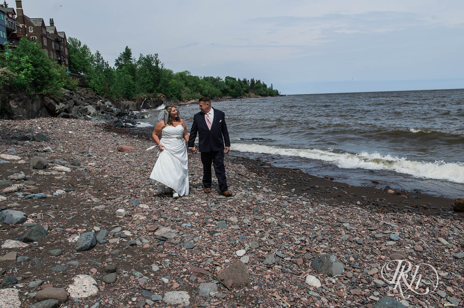 Bride and groom walking along Lake Superior in Duluth