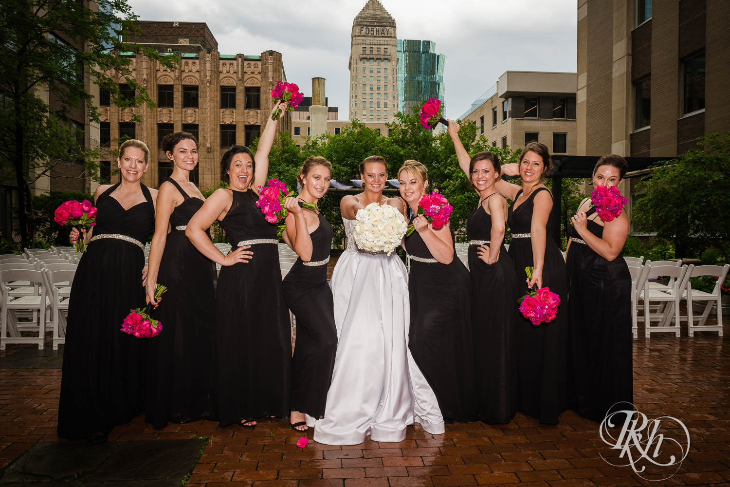 Wedding party smiles with bride at Crowne Plaza Minneapolis Northstar Downtown in Minneapolis, Minnesota.