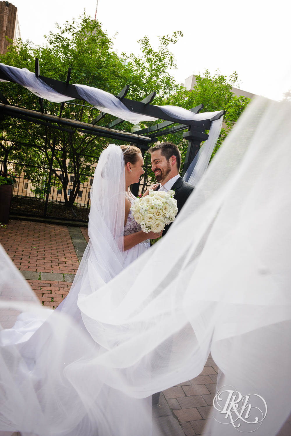 Bride and groom kiss at Crowne Plaza Minneapolis Northstar Downtown in Minneapolis, Minnesota.