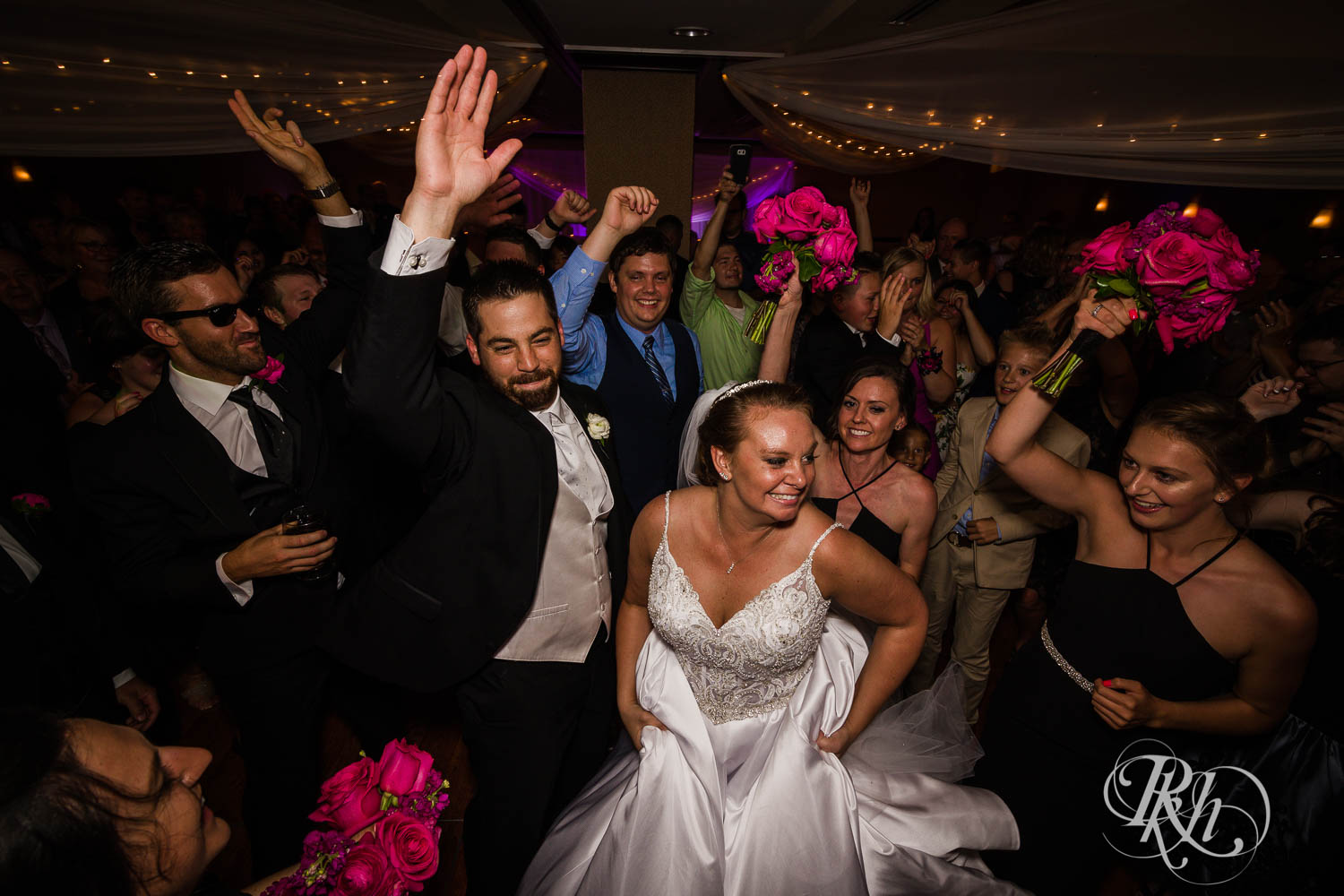 Bride and groom dance with guests at Crowne Plaza Minneapolis Northstar Downtown in Minneapolis, Minnesota.