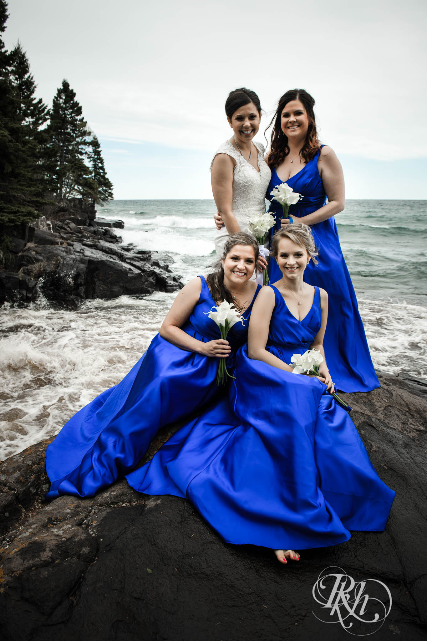 Wedding party smiles in front of Lake Superior in North Shore in Minnesota.