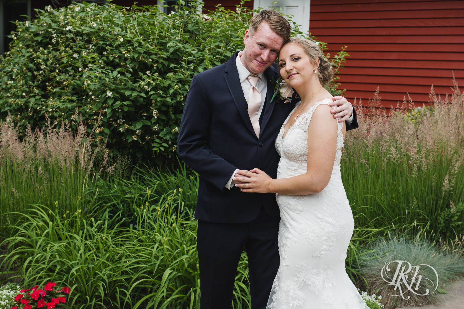 Bride and groom smile on wedding day at Earle Brown Heritage Center in Brooklyn Center, Minnesota.