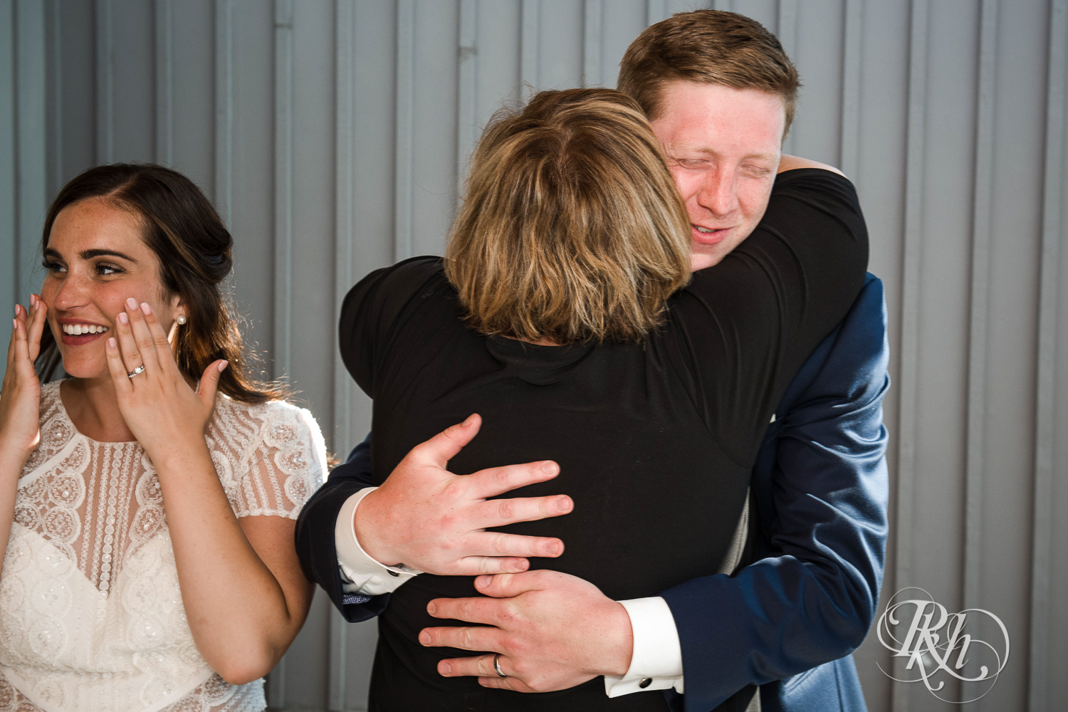 Groom hugs mom and bride cries during their Bluefin Bay wedding in Tofte, Minnesota.