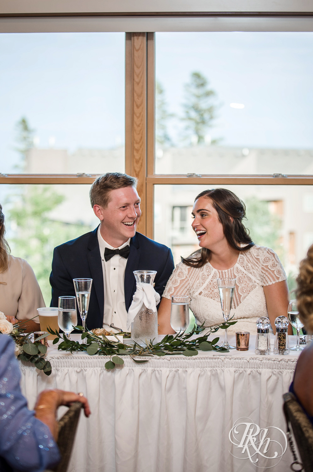 Bride and groom smile during wedding reception during their Bluefin Bay wedding in Tofte, Minnesota.