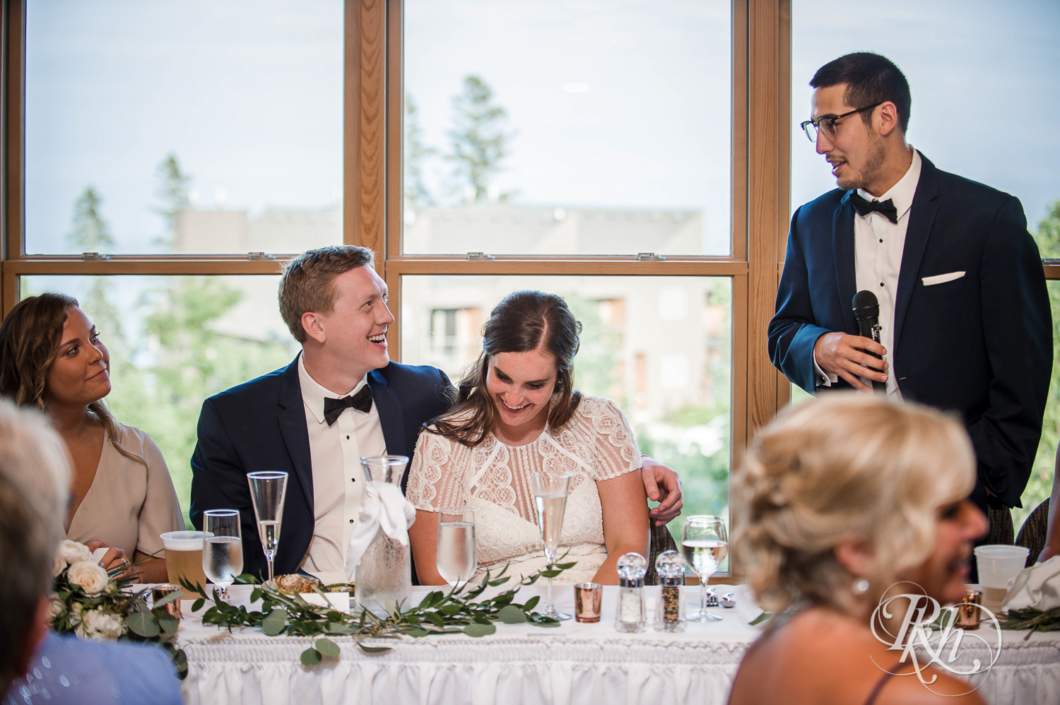 Bride and groom smile during wedding reception during their Bluefin Bay wedding in Tofte, Minnesota.