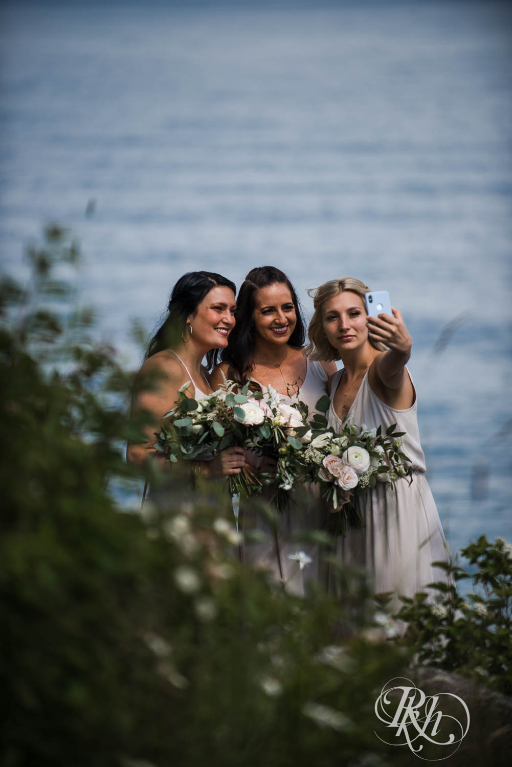 Bridesmaids take selfie at Bluefin Bay wedding in Tofte, Minnesota.