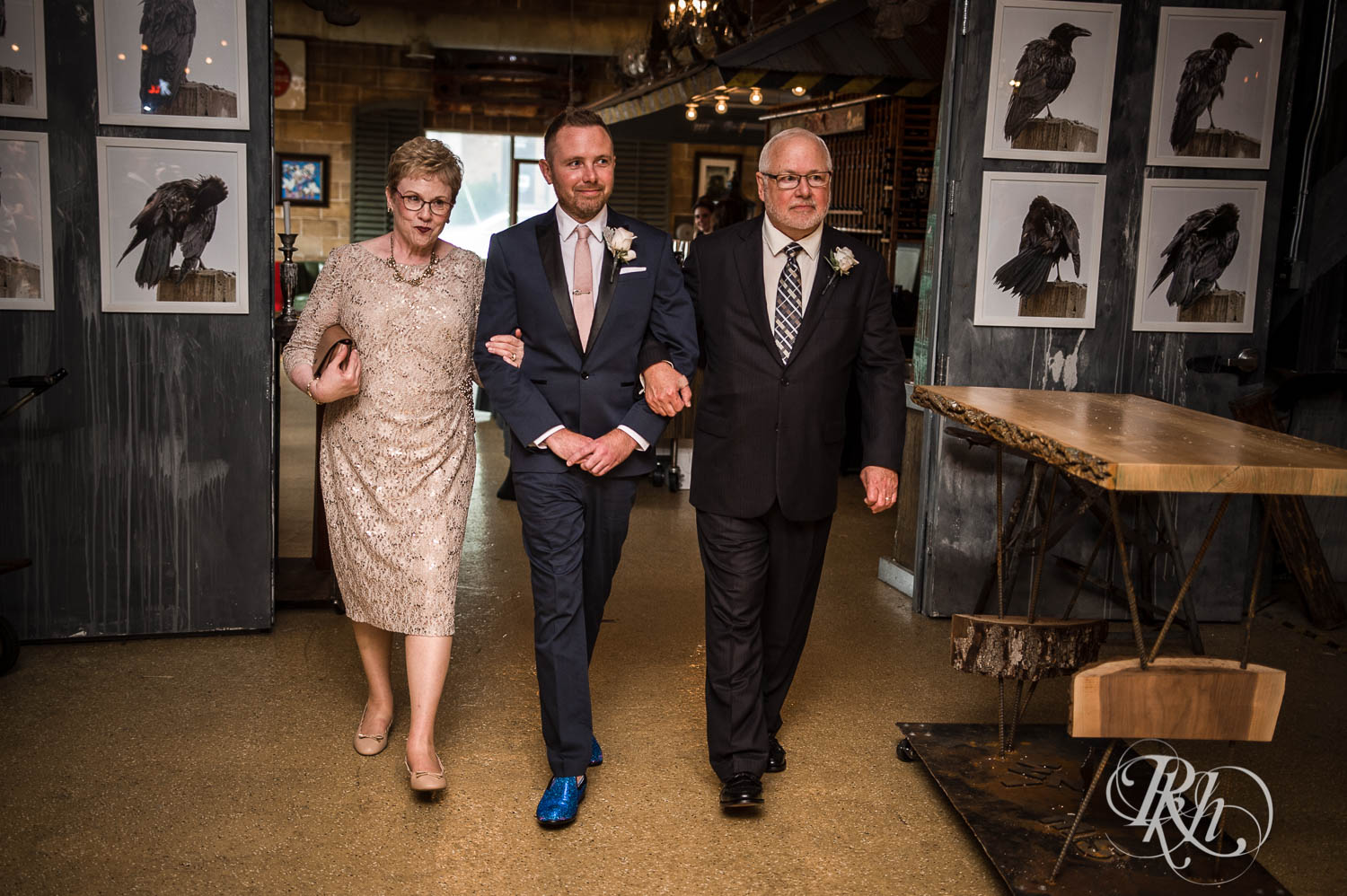 Groom walks down the aisle with parents at Warehouse Winery wedding in Saint Louis Park, Minnesota.