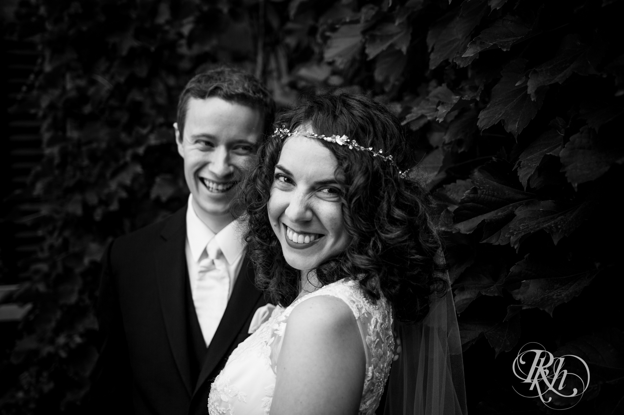 Bride and groom smile at the Saint Paul Hotel in Saint Paul, Minnesota.