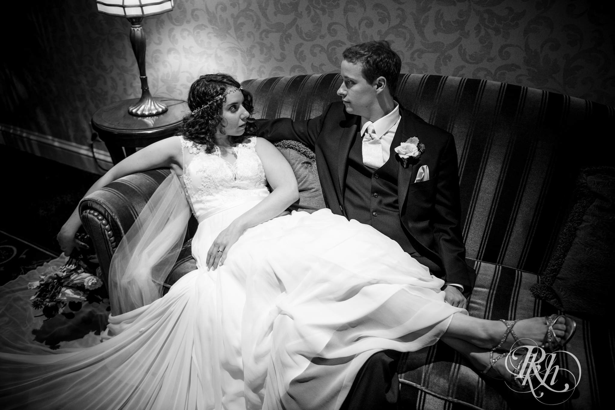 Bride and groom sitting on couch at the Saint Paul Hotel in Saint Paul, Minnesota.