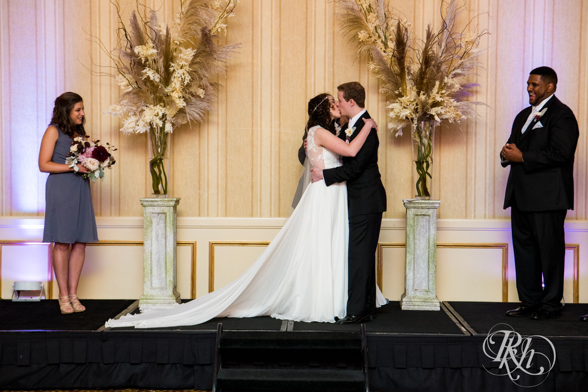 Bride and groom kiss during wedding ceremony at the Saint Paul Hotel in Saint Paul, Minnesota.