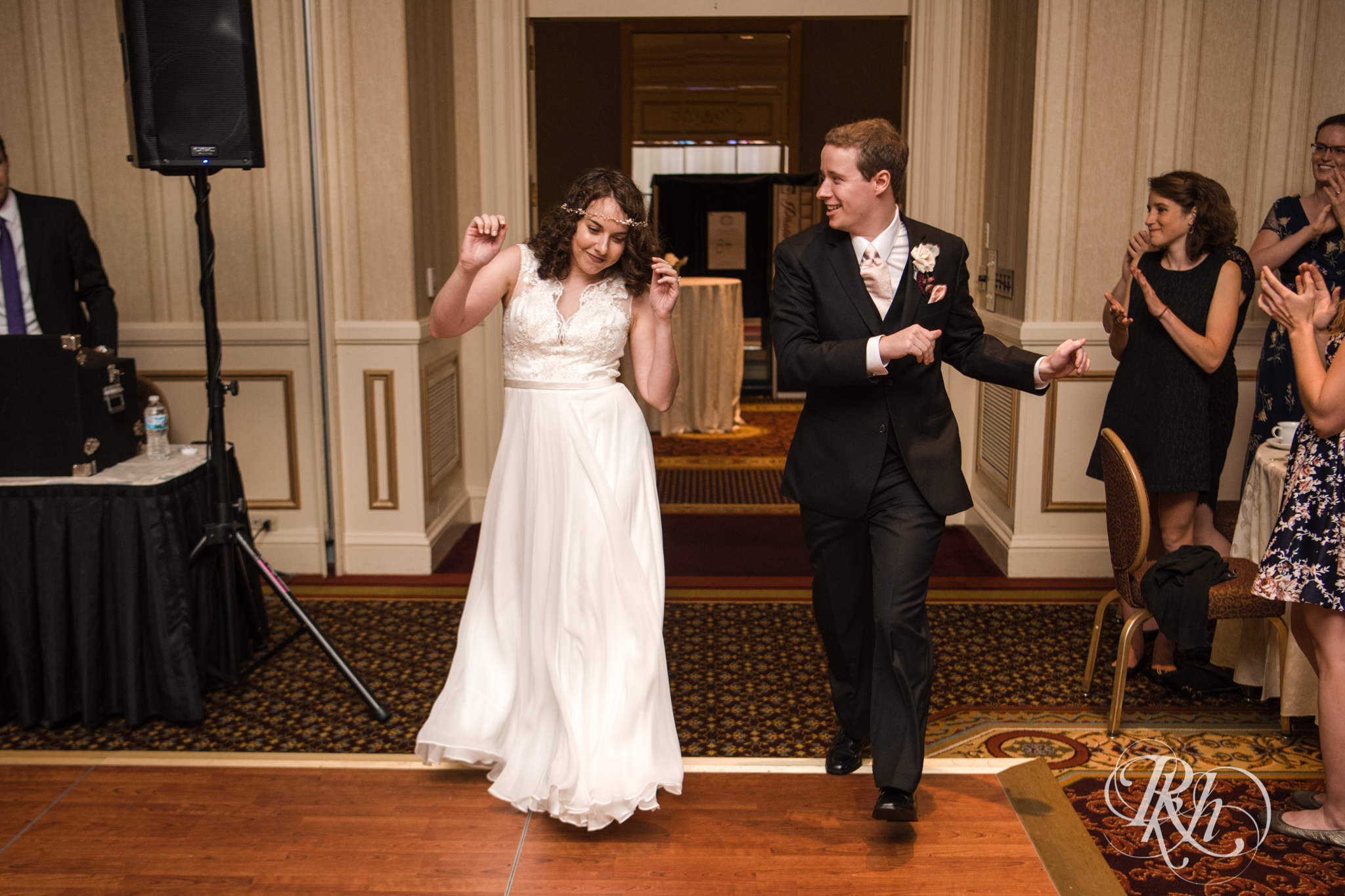 Bride and groom enter wedding reception at the Saint Paul Hotel in Saint Paul, Minnesota.