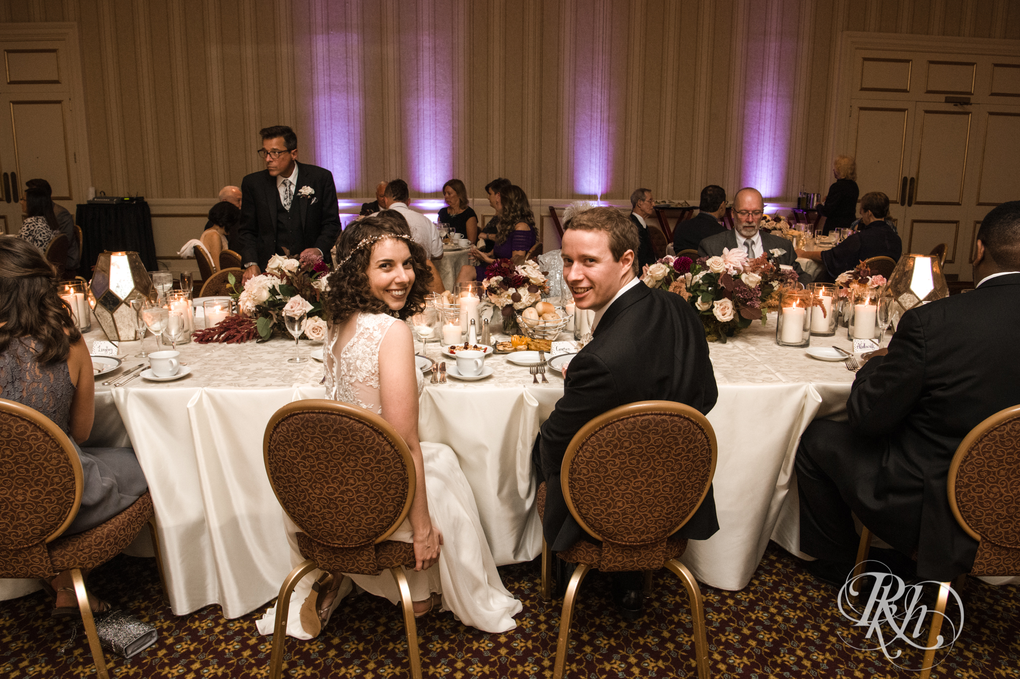 Bride and groom smile during wedding reception at the Saint Paul Hotel in Saint Paul, Minnesota.