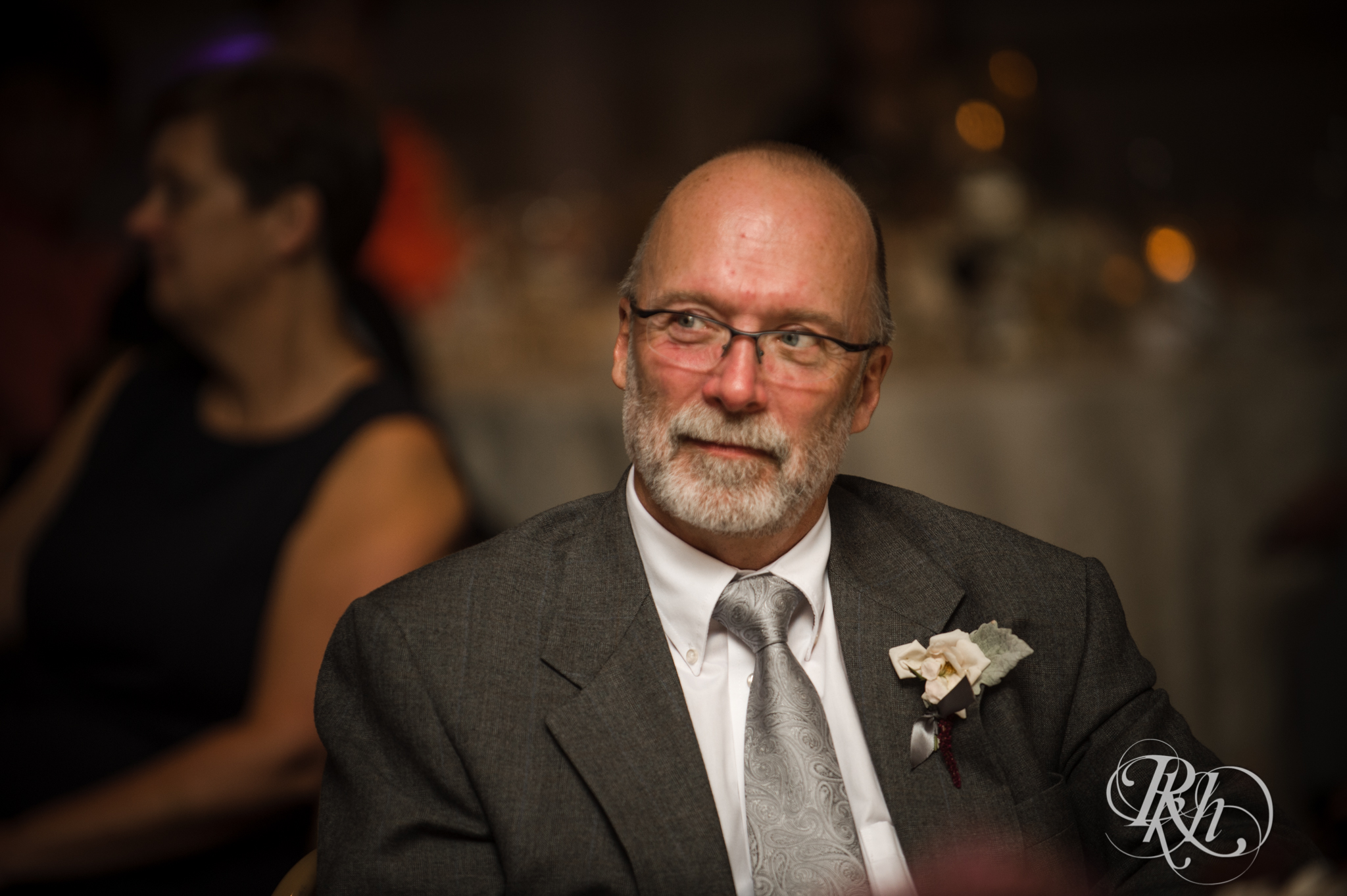 Father of groom smiles during wedding reception at the Saint Paul Hotel in Saint Paul, Minnesota.
