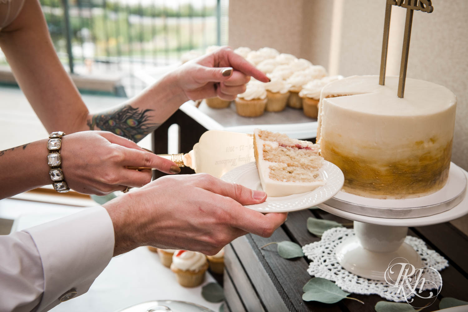 Bride and groom cut cake during wedding reception at Plymouth Creek Center in Plymouth, Minnesota.