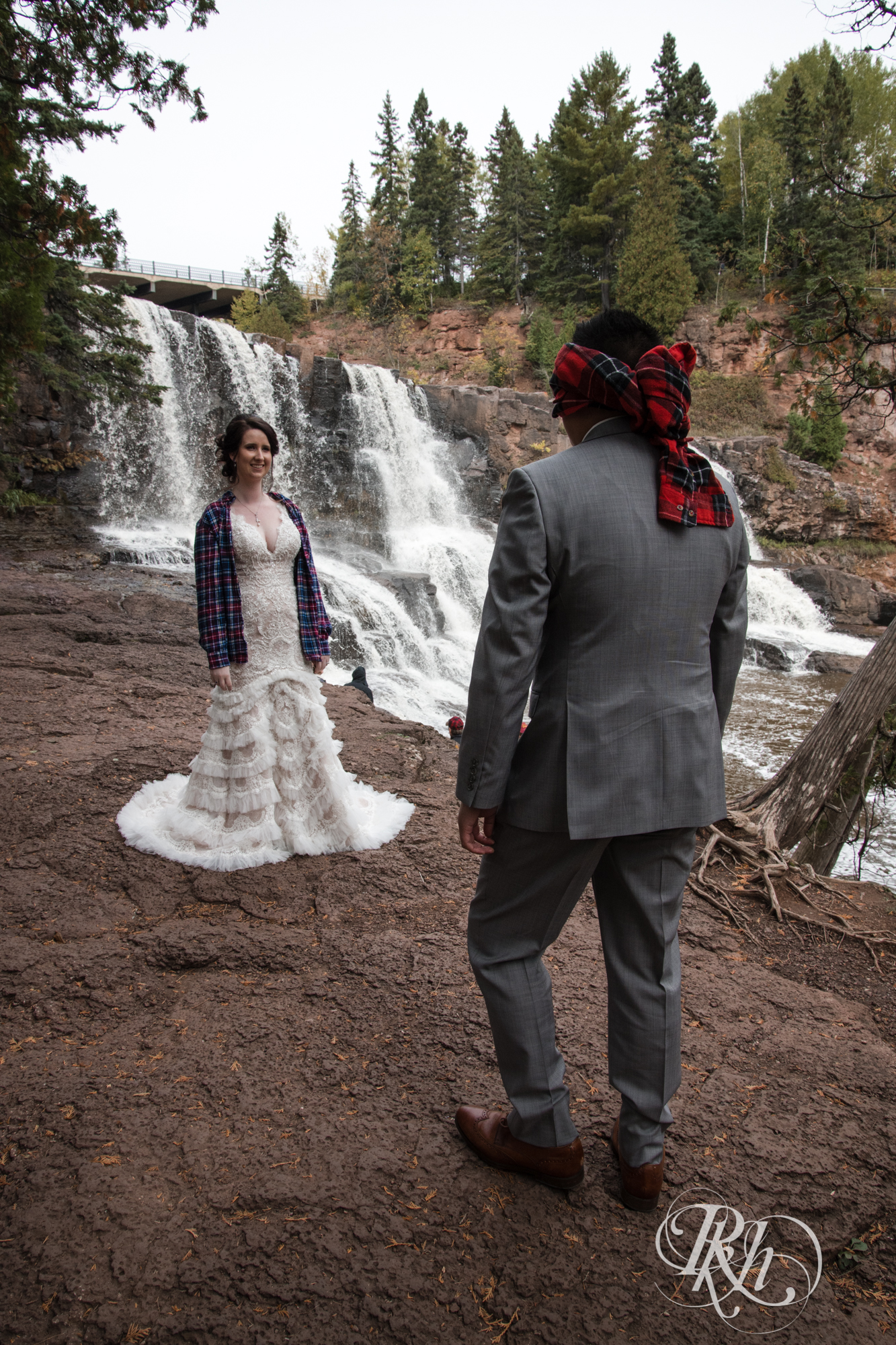 Bride and groom doing first look at Gooseberry Falls in Two Harbors, Minnesota.