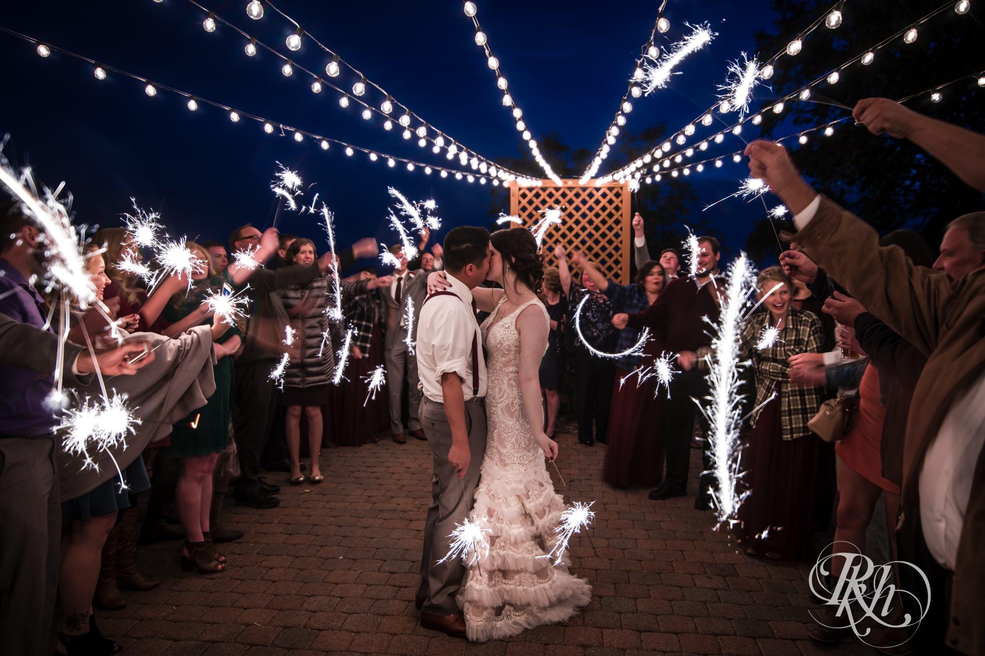Bride and groom kiss surrounded by sparklers at Grand Superior Lodge in Two Harbors, Minnesota.