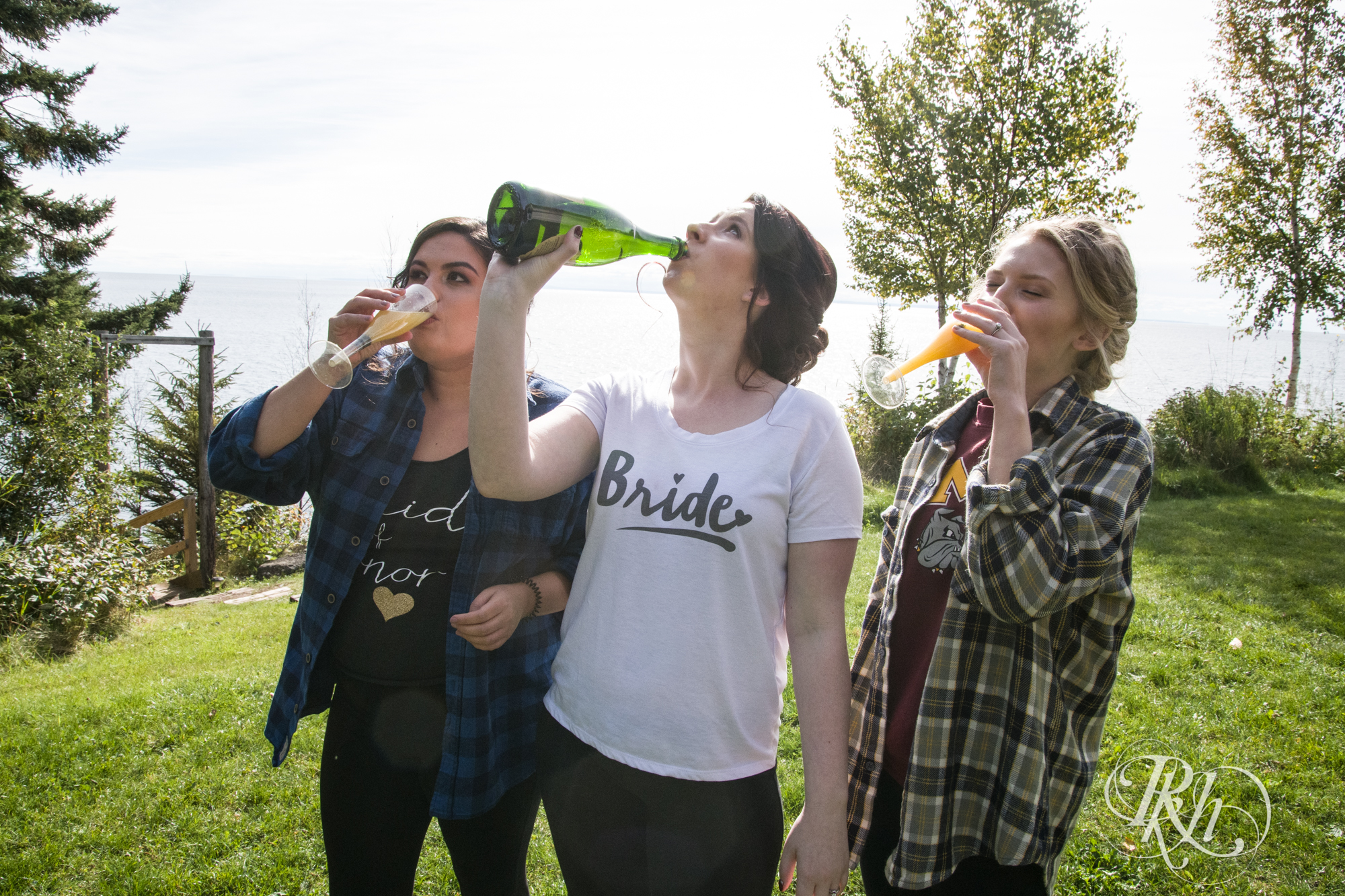Bride drinking champagne with bridesmaids at Grand Superior Lodge in Two Harbors, Minnesota.