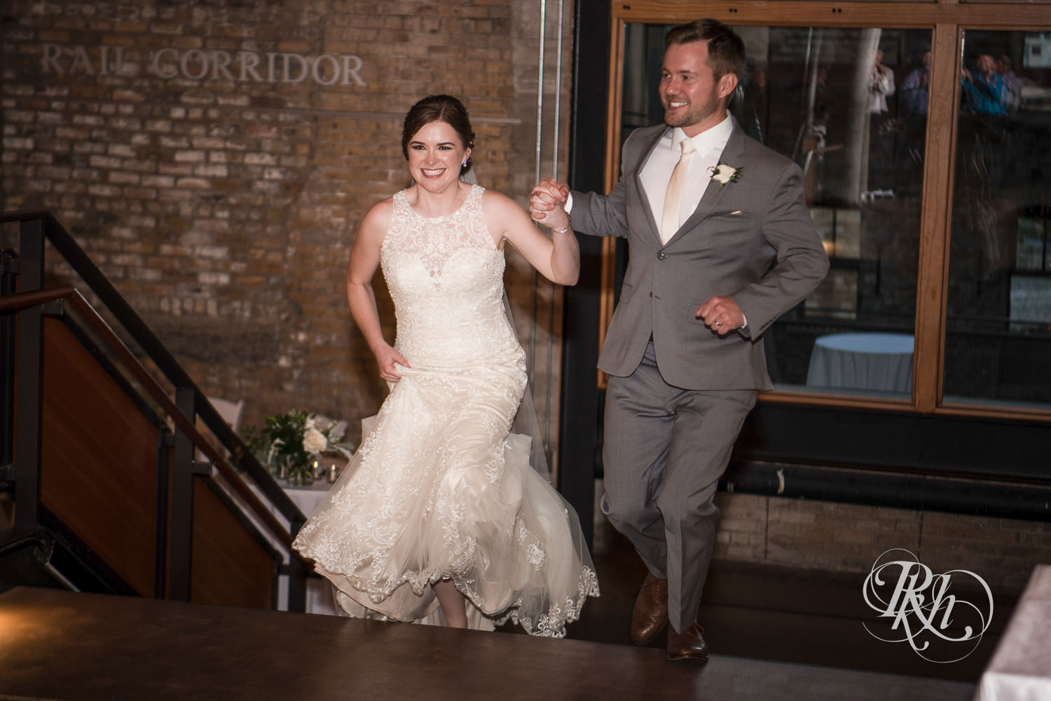 Bride and groom enter wedding reception at Mill City Museum in Minneapolis, Minnesota.