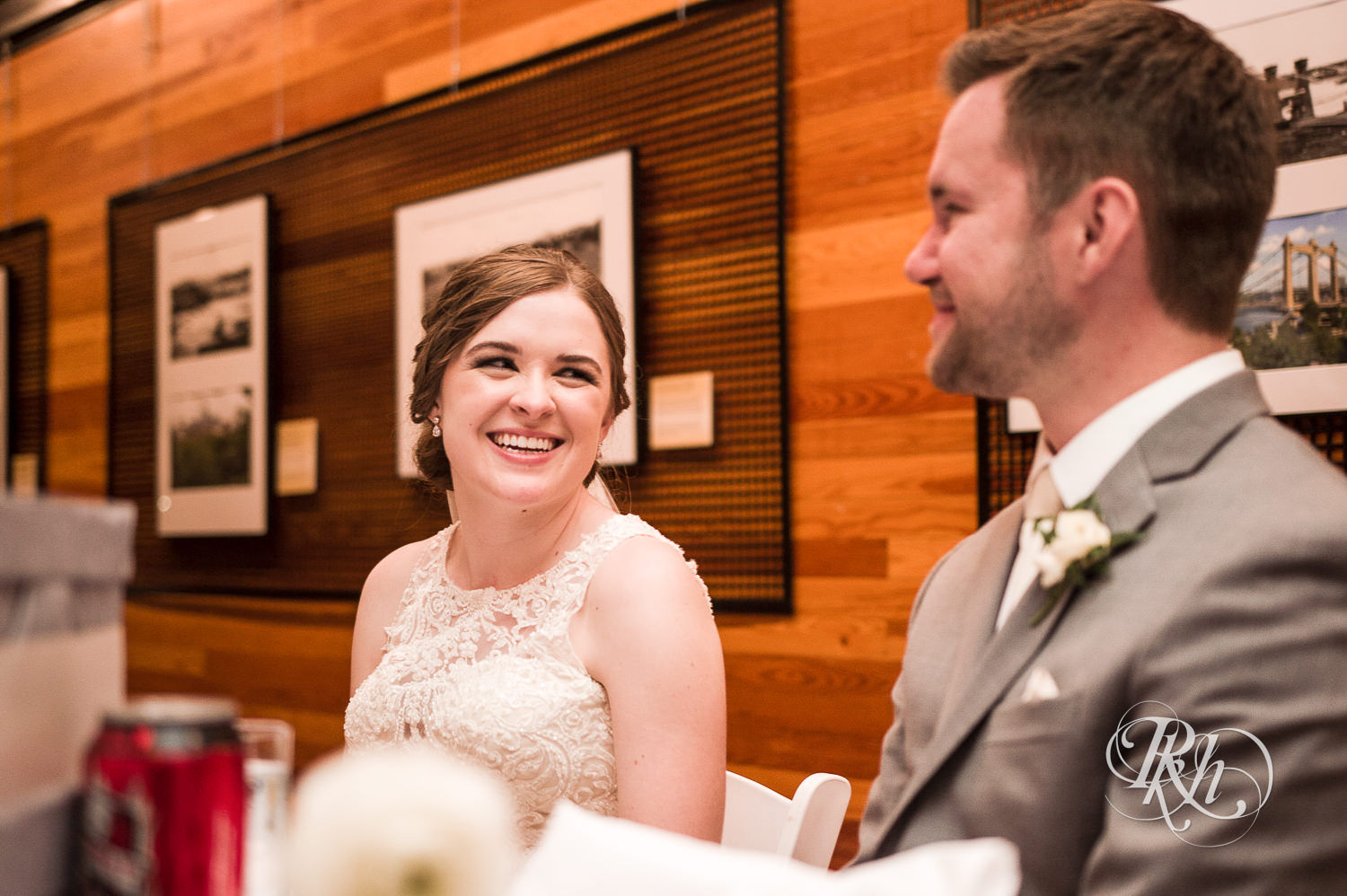Bride and groom smile during wedding reception at Mill City Museum in Minneapolis, Minnesota.
