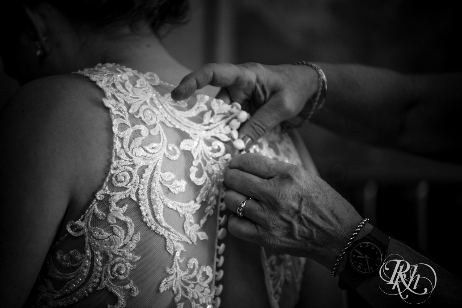 Bride getting buttoned into dress before wedding in Renaissance Hotel in Minneapolis, Minnesota. 