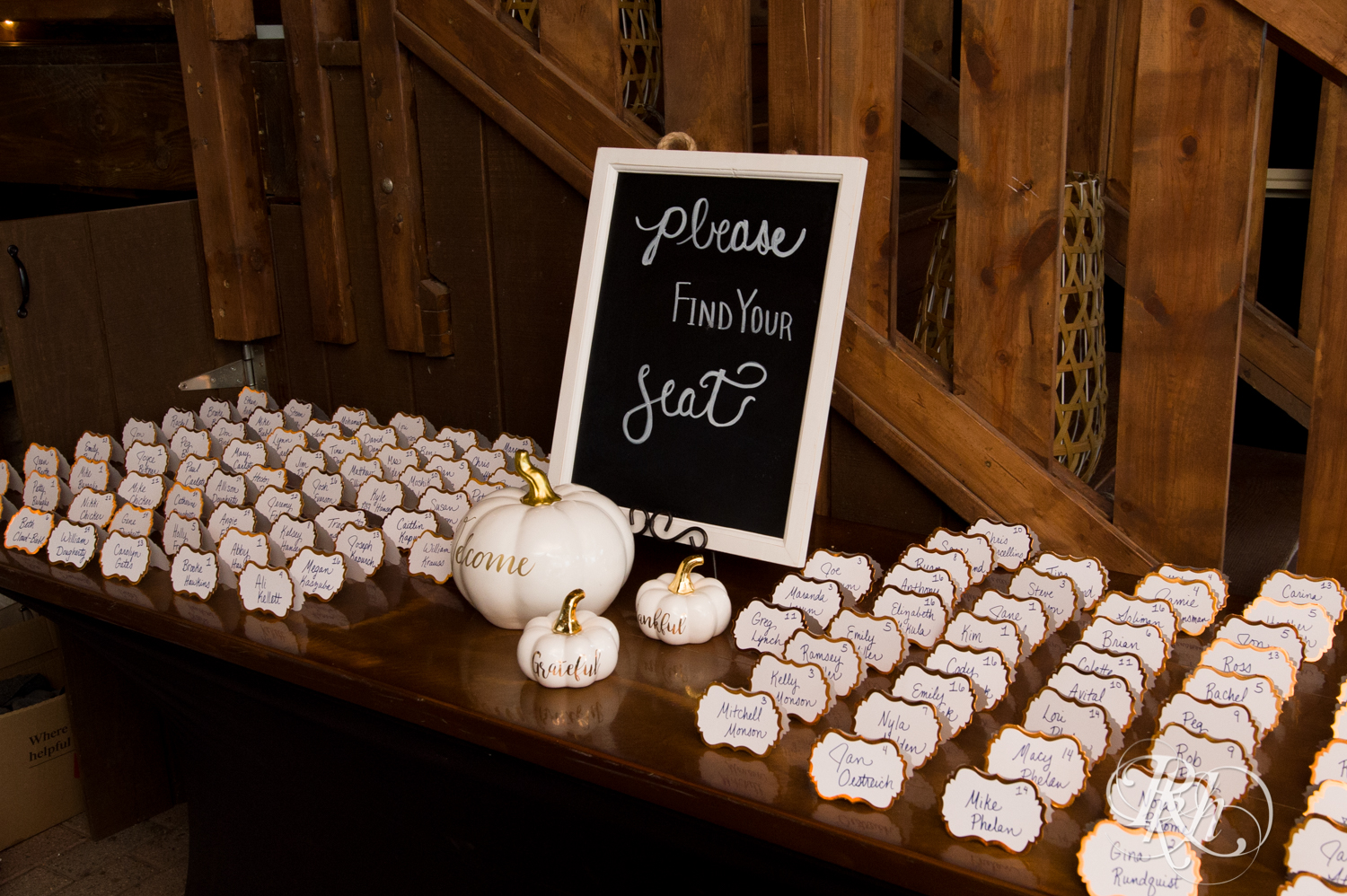 Table of placeholders and white pumpkins setup at Mayowood Stone Barn in Rochester, Minnesota.