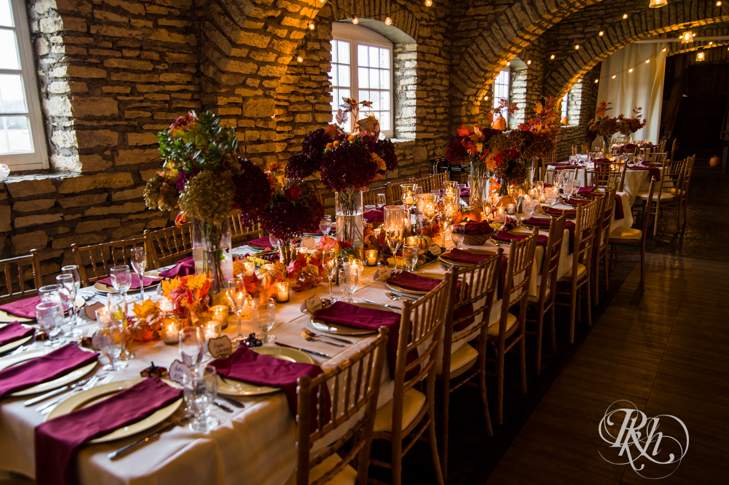 Halloween wedding reception setup with red and orange details at Mayowood Stone Barn in Rochester, Minnesota.