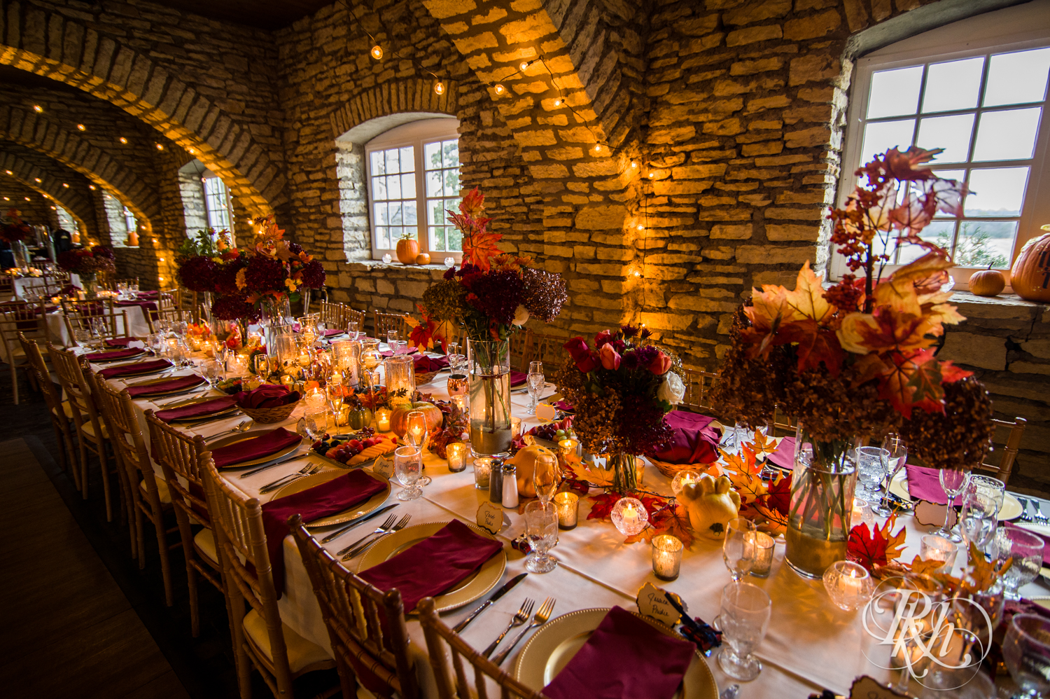 Halloween wedding reception setup with red and orange details at Mayowood Stone Barn in Rochester, Minnesota.