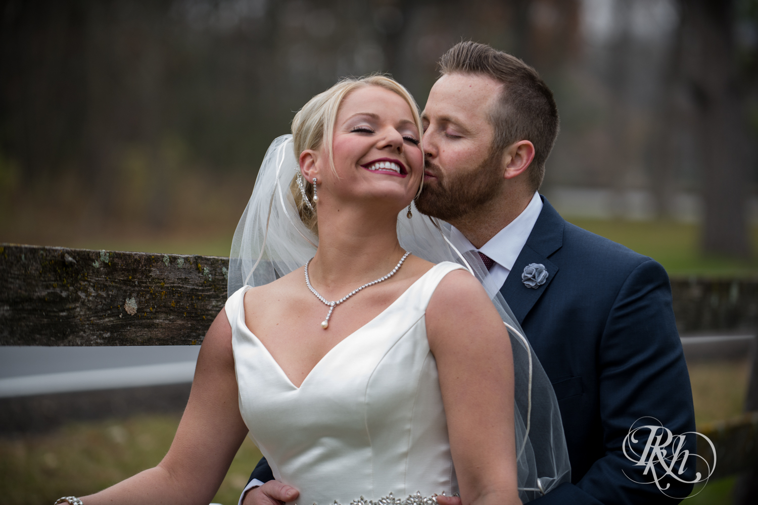 Bride and groom kiss at Mayowood Stone Barn in Rochester, Minnesota.